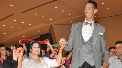 World’s Tallest Man Says That Being Eight Foot Three Inches Is “Not Easy”