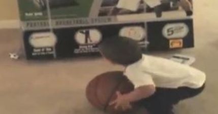 VIDEO: Toddler Tries Throwing Basketball Through Picture of a Hoop