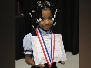 A 7-year-old born without hands has won a national handwriting competition