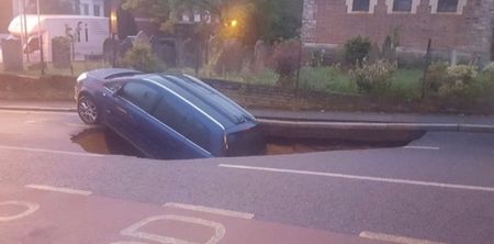 A huge sinkhole has appeared in a road in London and swallowed a car