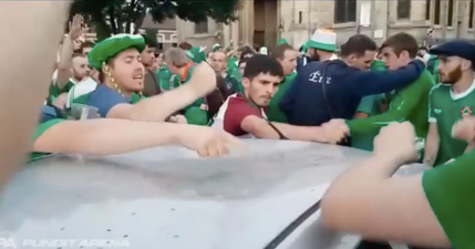 Irish fans sing while fixing a dent in a car in France