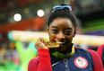 Here’s why Olympians bite their medals in photos
