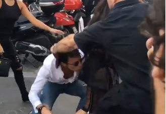 A prankster lunged at Kim Kardashian in an attempt to kiss her bum