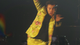 Harry Styles takes a tumble after fans throw kiwis onto the stage