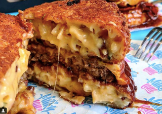 This mac and cheese burger has pasta for buns and we are ready for it to be within us