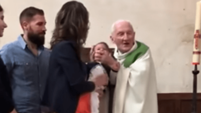 The priest who was seen slapping a crying baby has tried to explain his actions