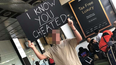 Man waits at airport with ‘I know you cheated’ sign for partner and holy mother of God