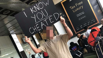 Man waits at airport with ‘I know you cheated’ sign for partner and holy mother of God