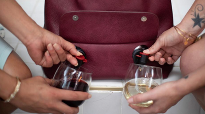 This handbag has two wine spouts and we NEED it for our BFFs
