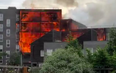A hundred firefighters are battling a massive fire at block of flats in east London